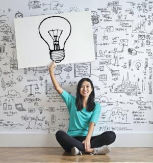 Person with lightbulb sign