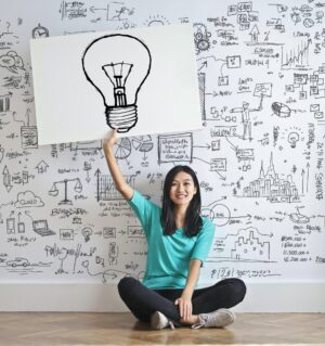 Person with lightbulb sign