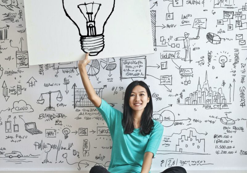 Person with lightbulb sign