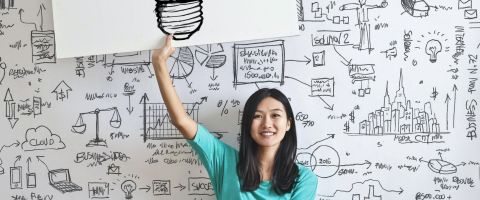 Person with lightbulb sign