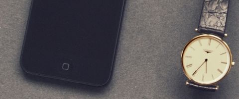 Phone, wallet, watch and glasses on table